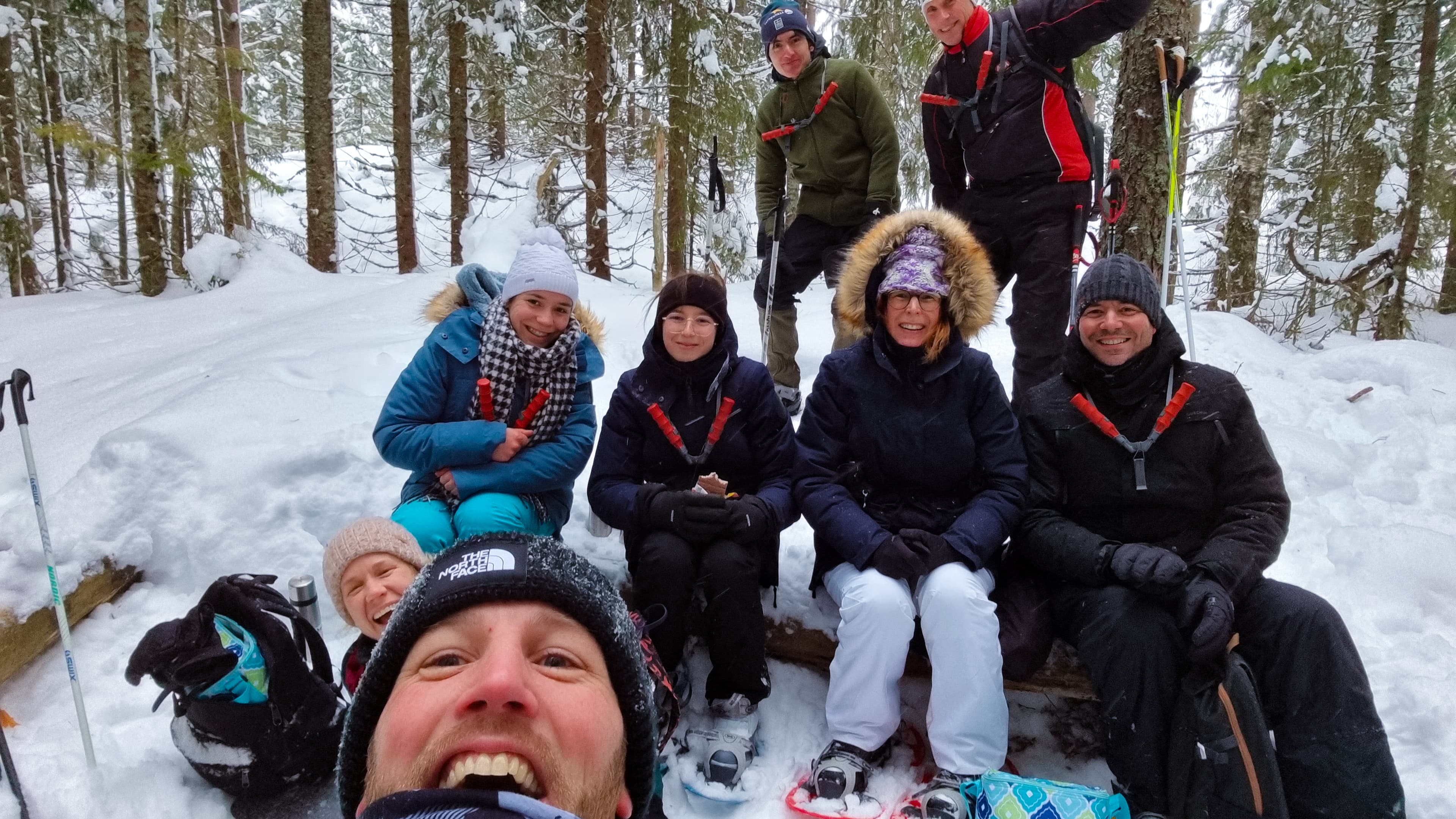 The group is taking a break during a wolf tracking tour in the snowy wilderness of Sweden.